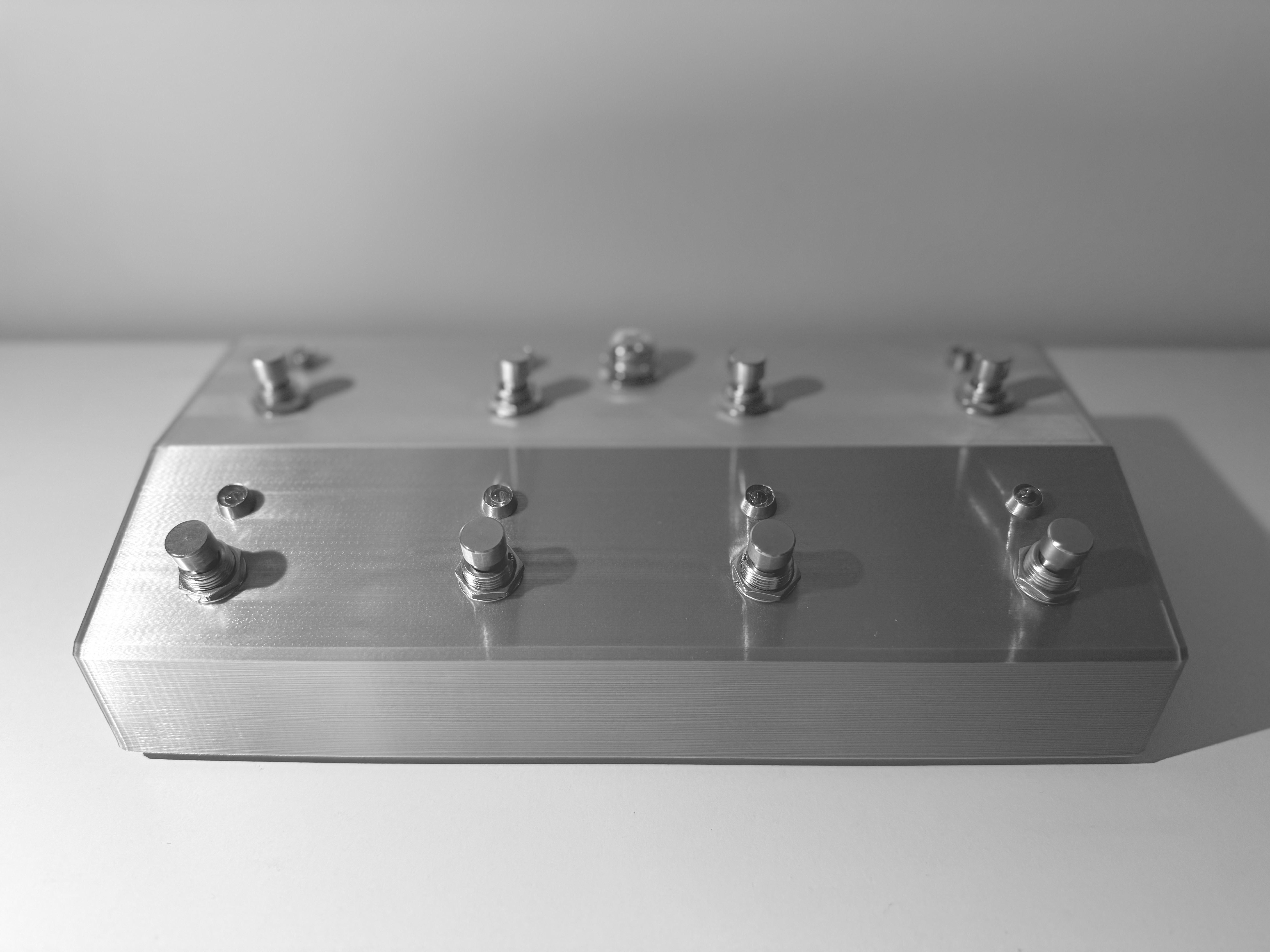 Eight-button MIDI footswitch in a silver textured enclosure