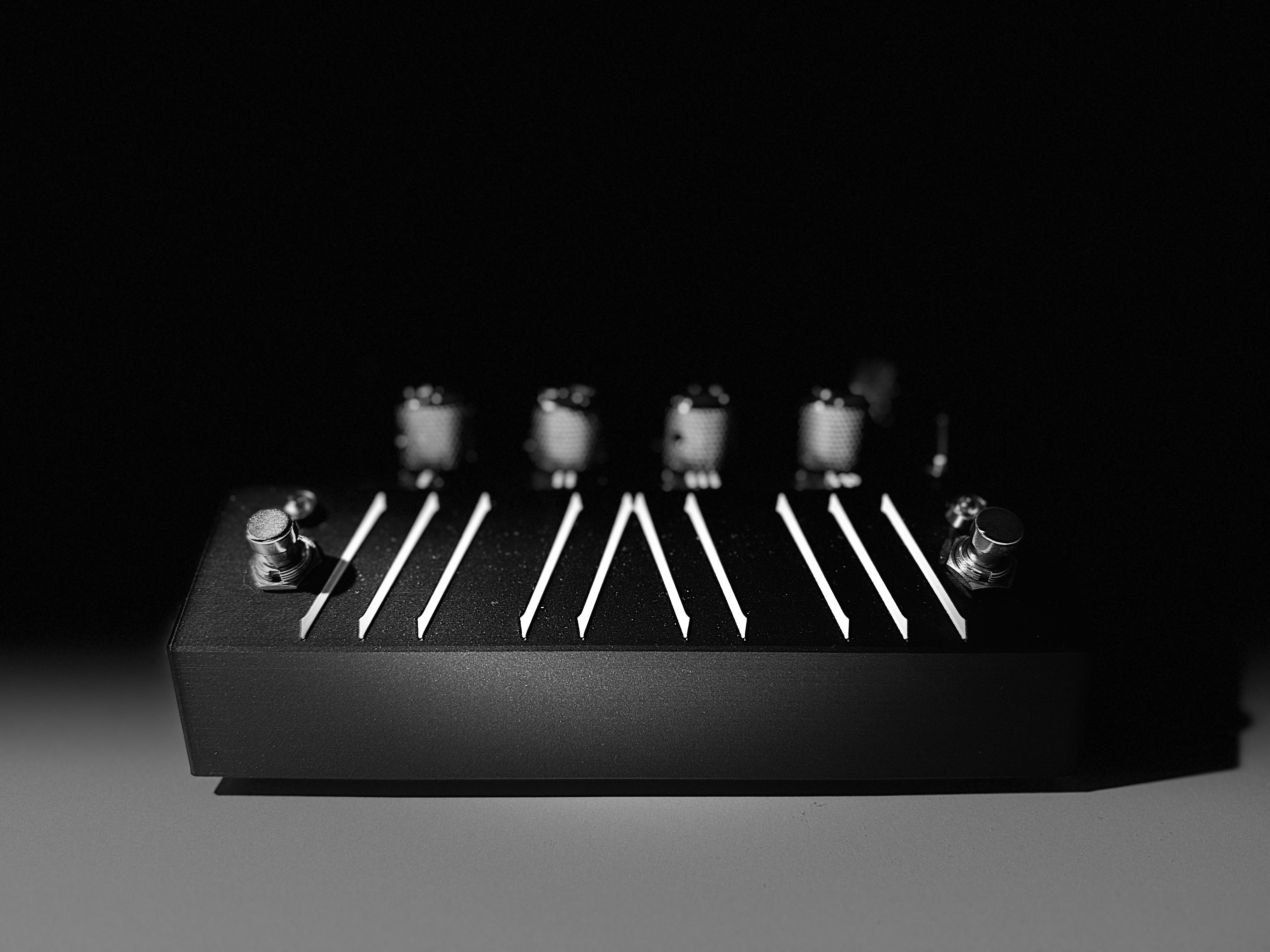 Top view of BonesFX showing the touchscreen, four knobs, and two footswitches