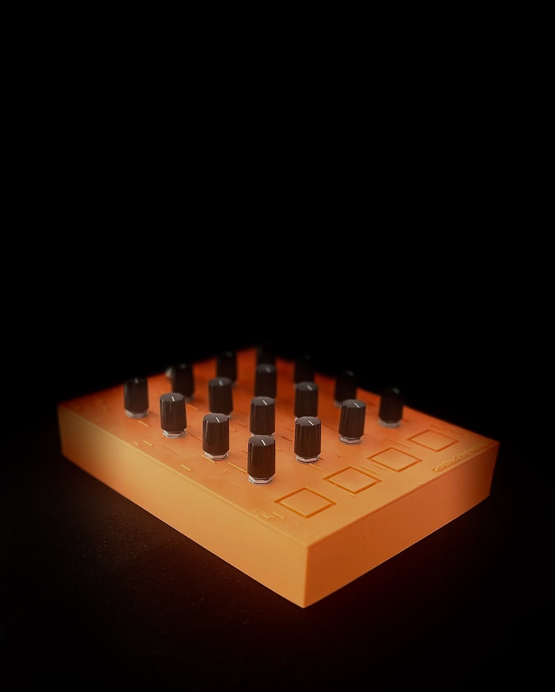 Orange GrimReach MIDI controller with sixteen knobs and four touch-bank controls