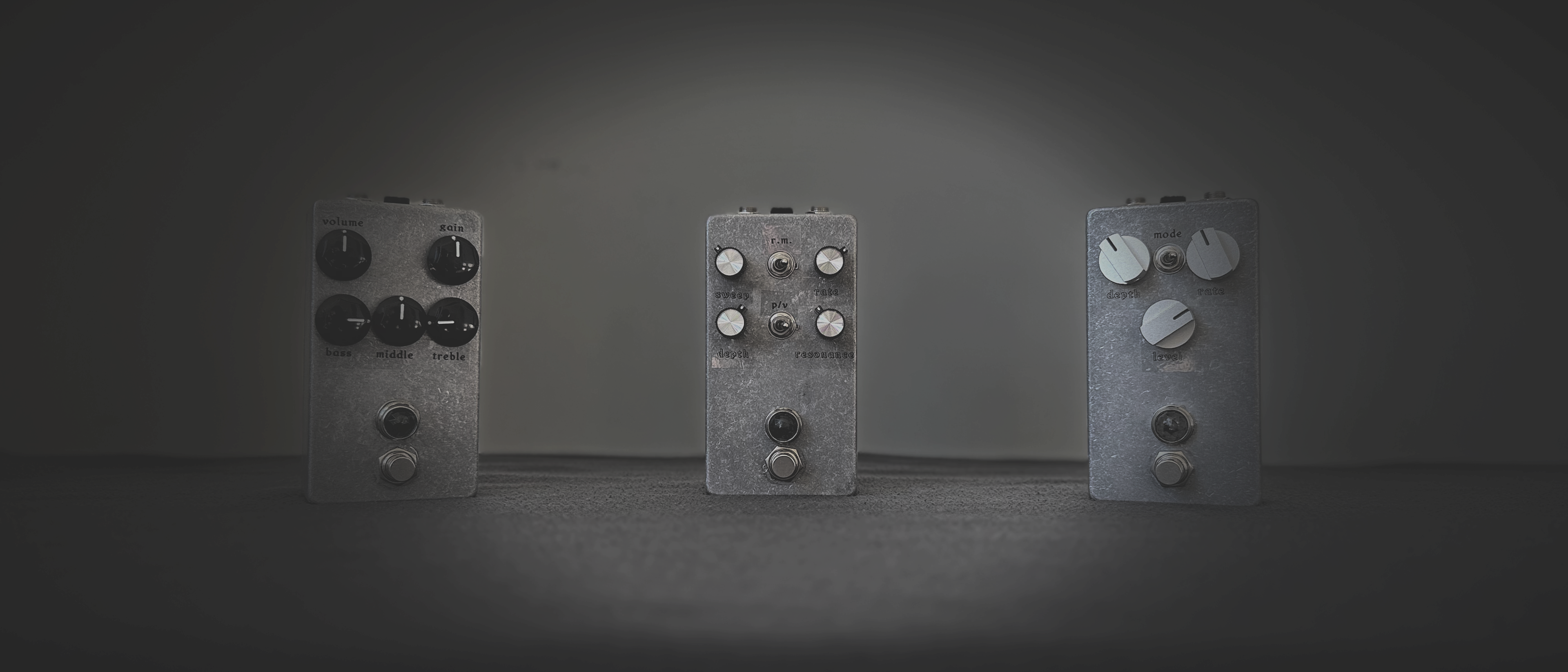 Three hand-built analog guitar pedals in metal enclosures